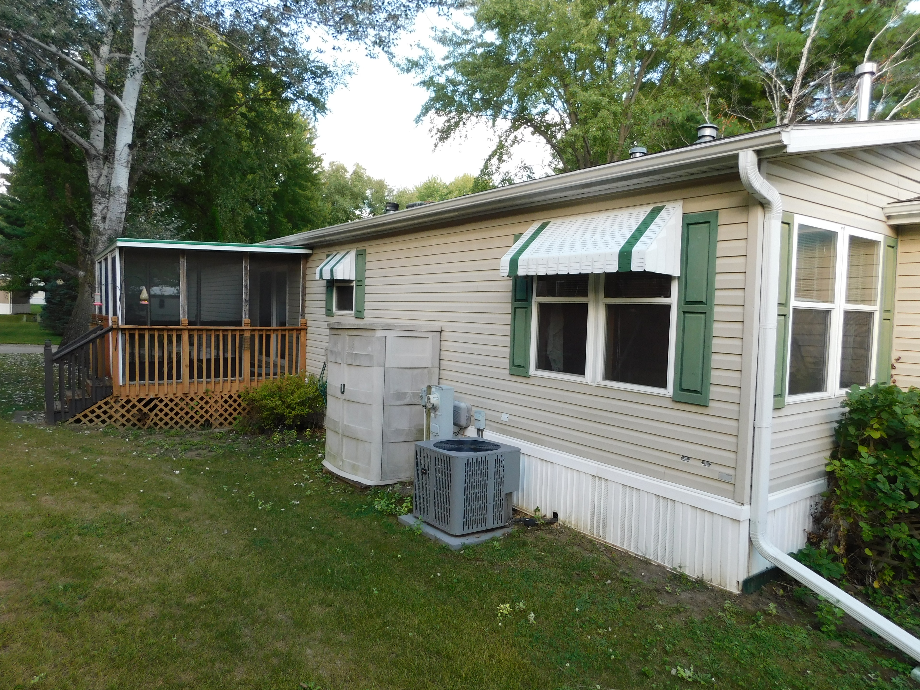 Exterior side with screened porch and A/C unit